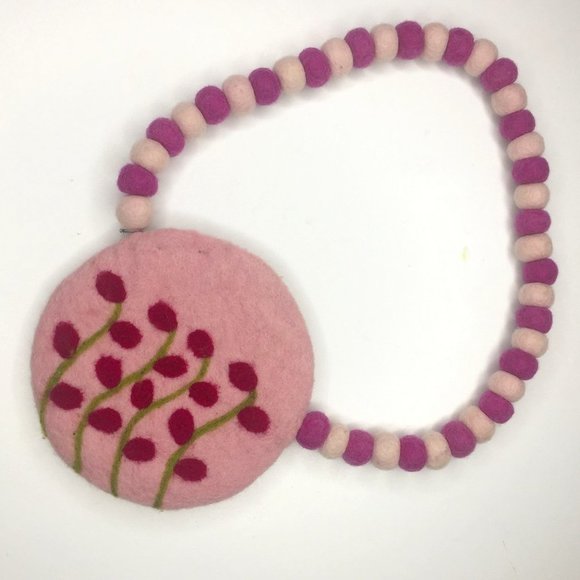 Felted wool purse with felted wool pompom strap and zippered opening in pink. - Picture 1 of 5